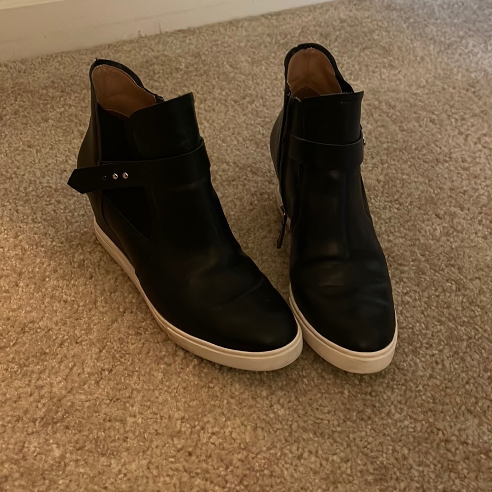 Black leather wedge bootie with white sole. Zips inside. Size 8.5. Runs narrow